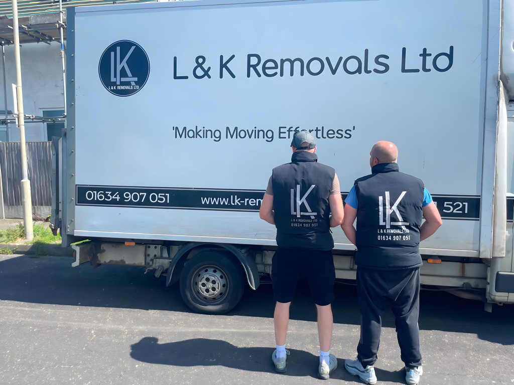 L&K Removals two-man team in branded uniforms beside removal truck