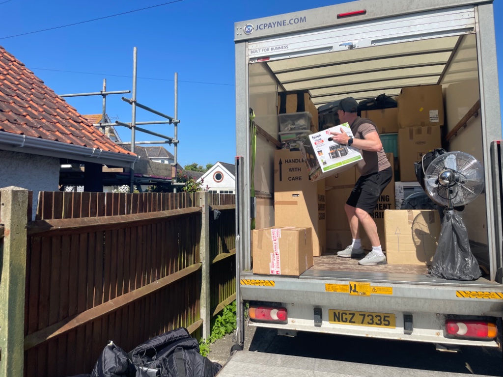 L&K Removals team member surveying living room ready for removal