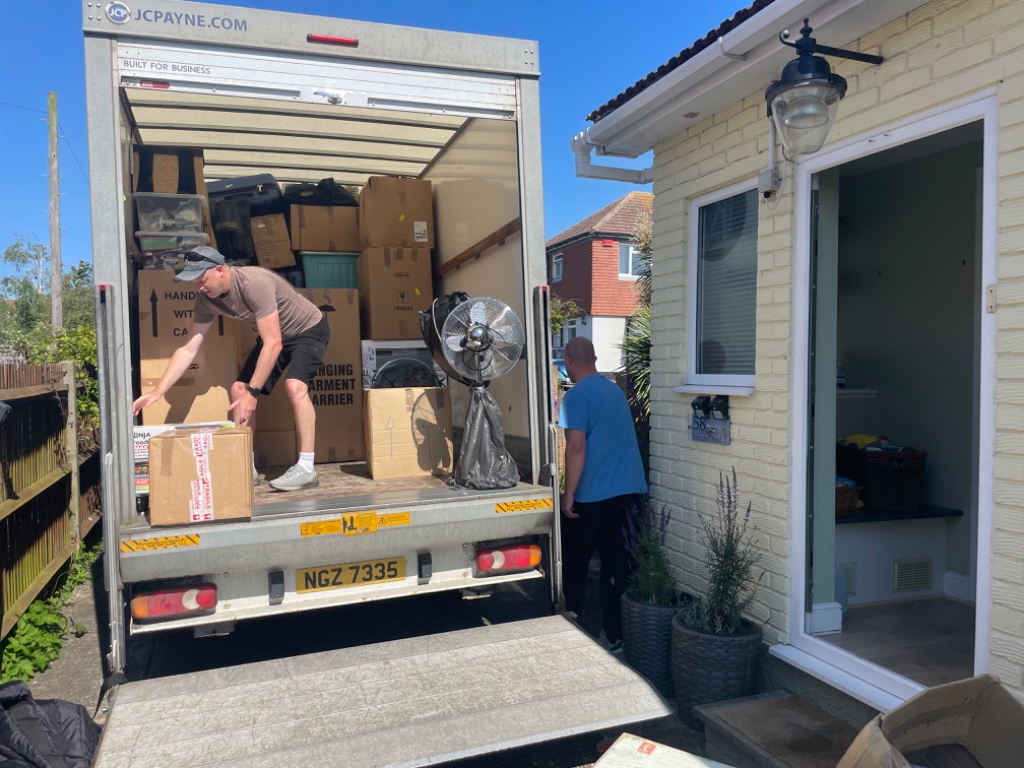 L&K Removals branded luton van front view in residential street