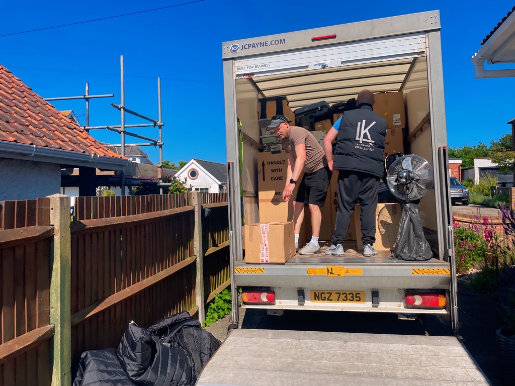 L&K Removals two man team unloading removal truck