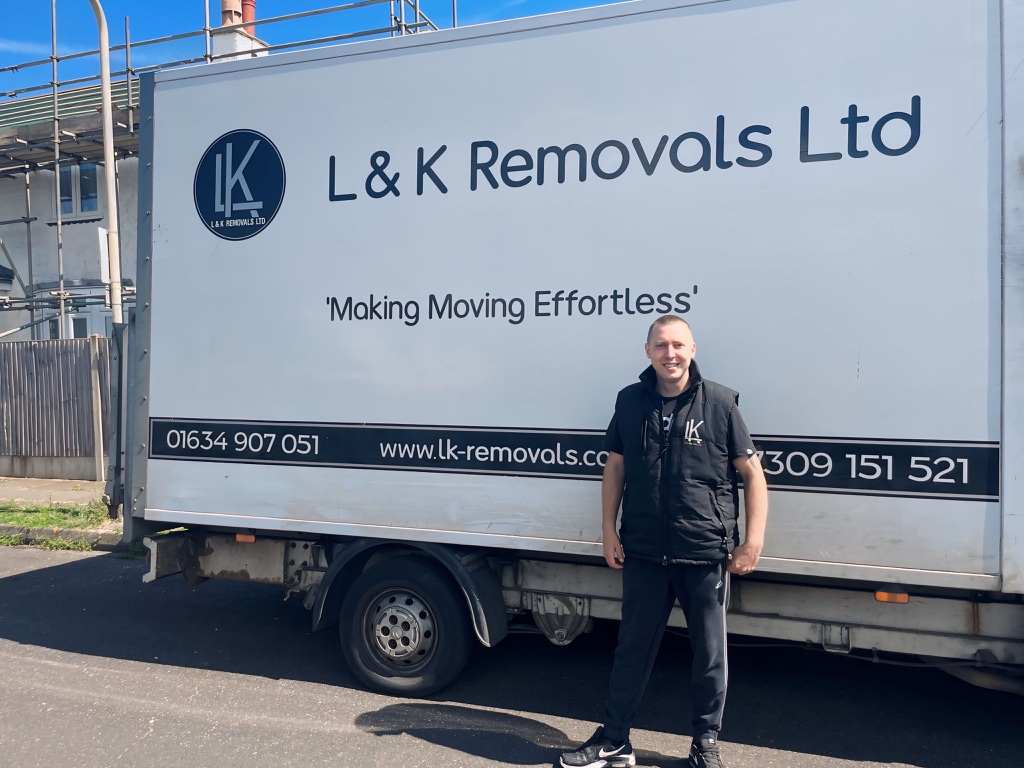 L&K Removals team leader standing by branded removal van