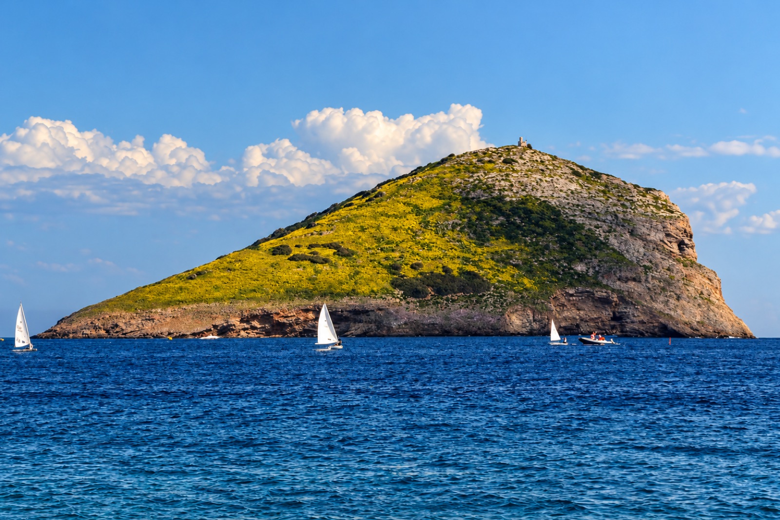 Rafti islet with sailboats in the bay of Porto Rafti, East Attica
