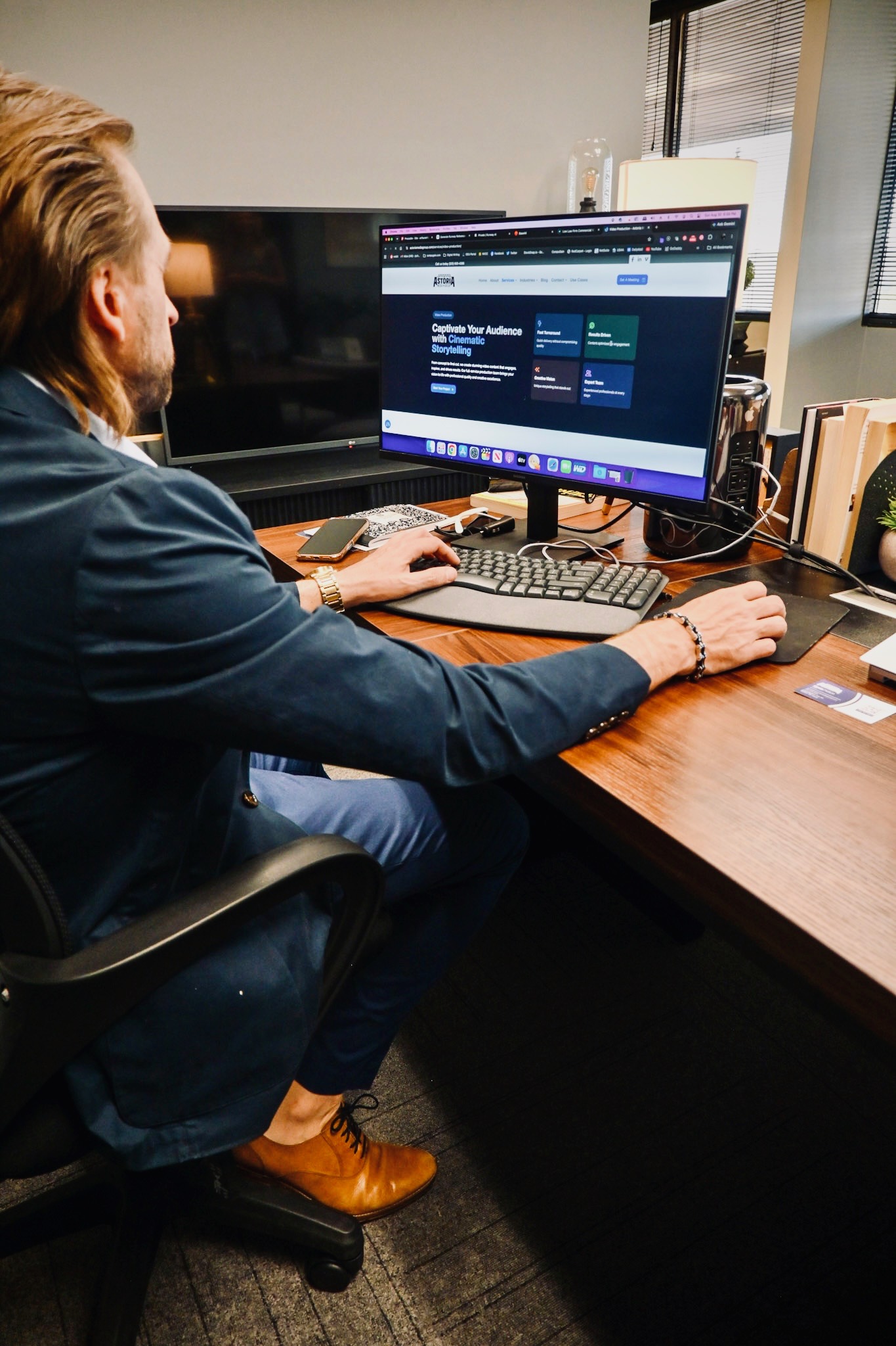 Astoria Media Group team member working at a desktop workstation