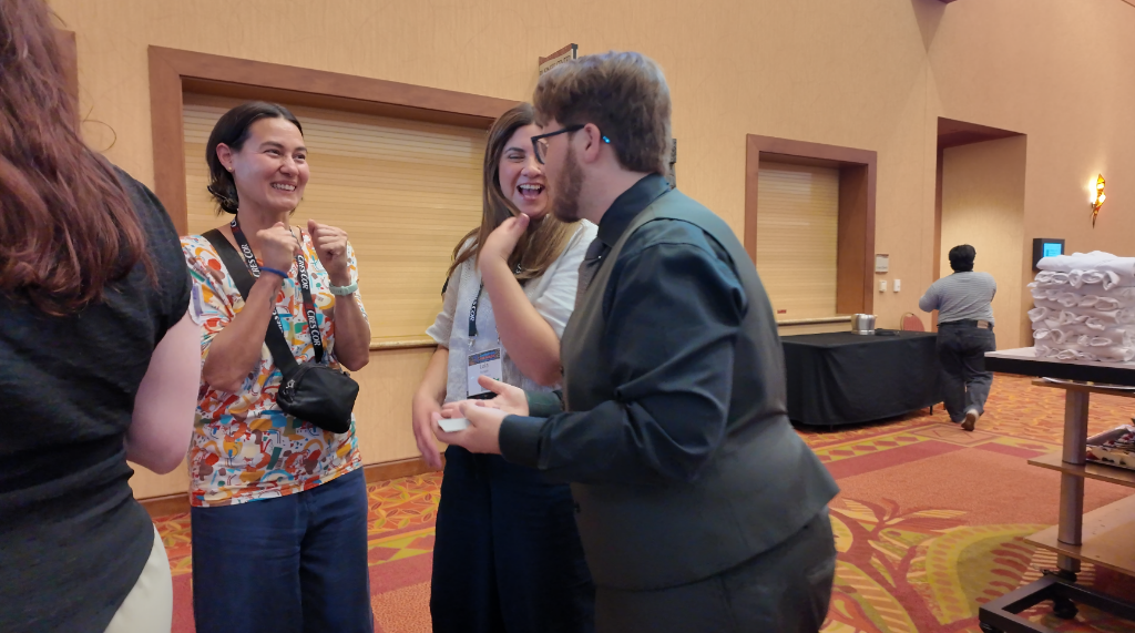Braden performing strolling close-up magic for conference attendees