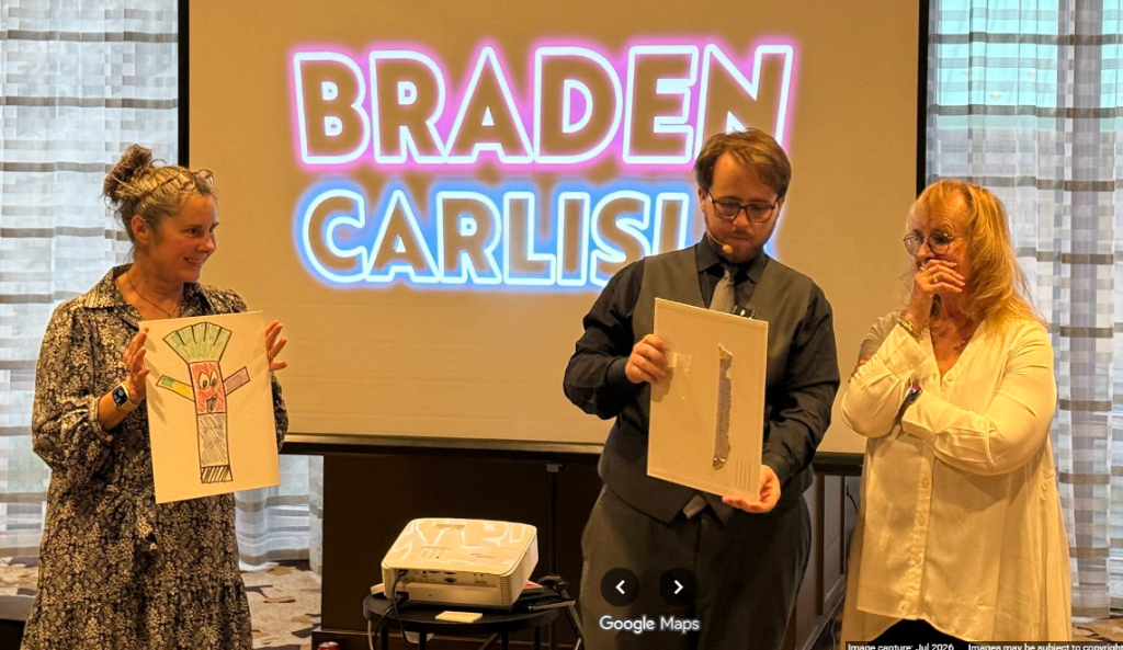 Braden performing a mentalism effect on stage with the COSA audience