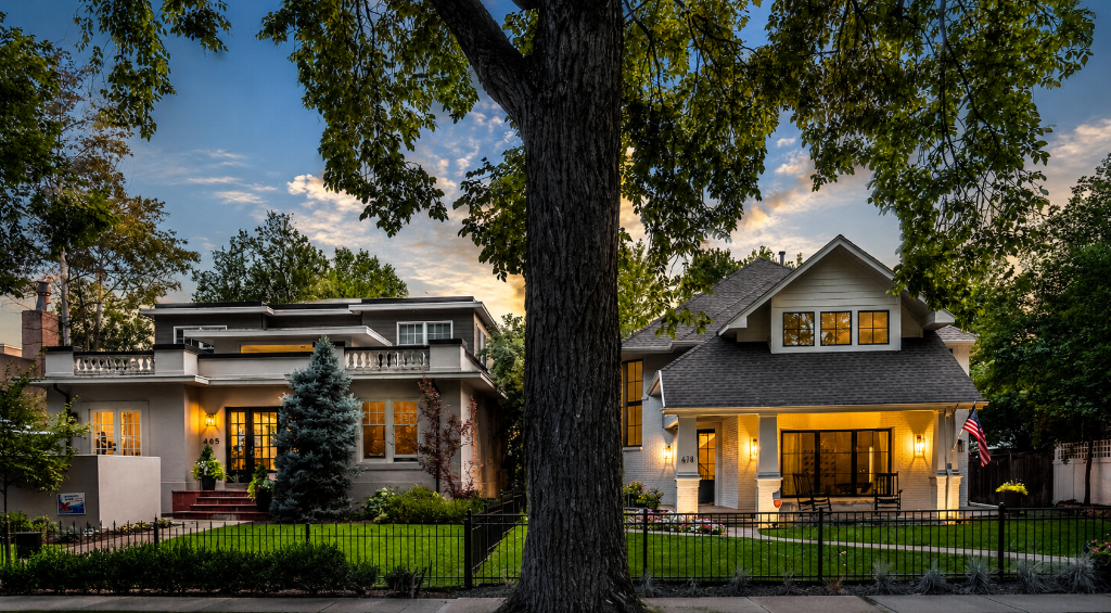 Denver Country Club neighborhood homes at dusk — luxury residences with warm glowing lights under twilight sky