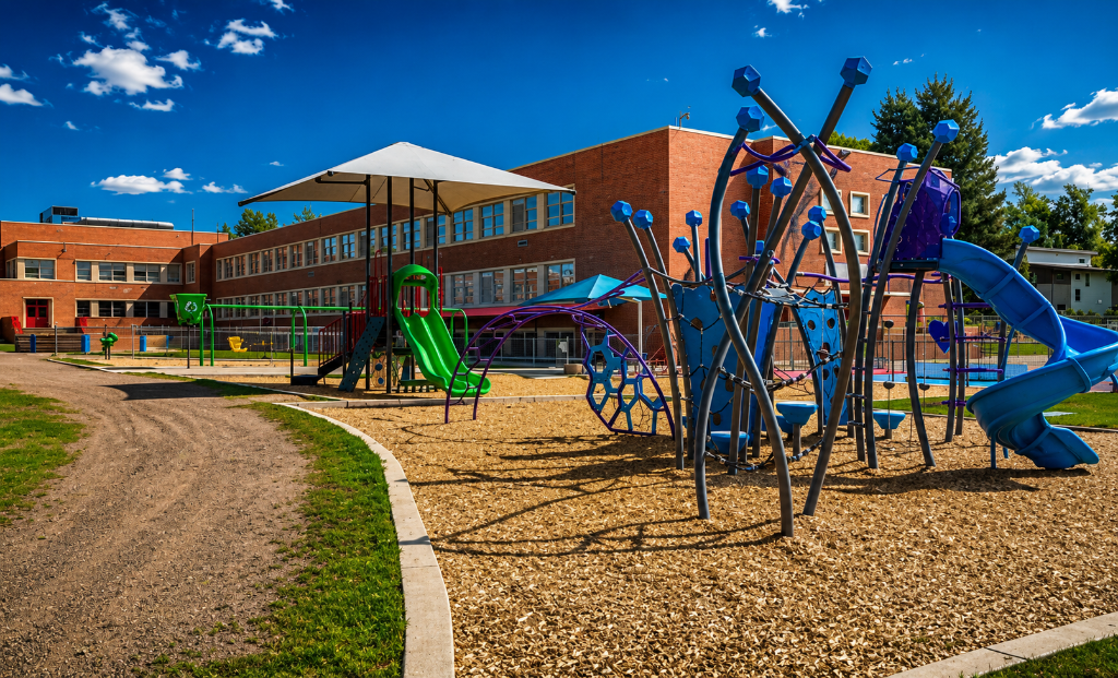 Cory Elementary School Denver — playground and school building under blue Colorado sky