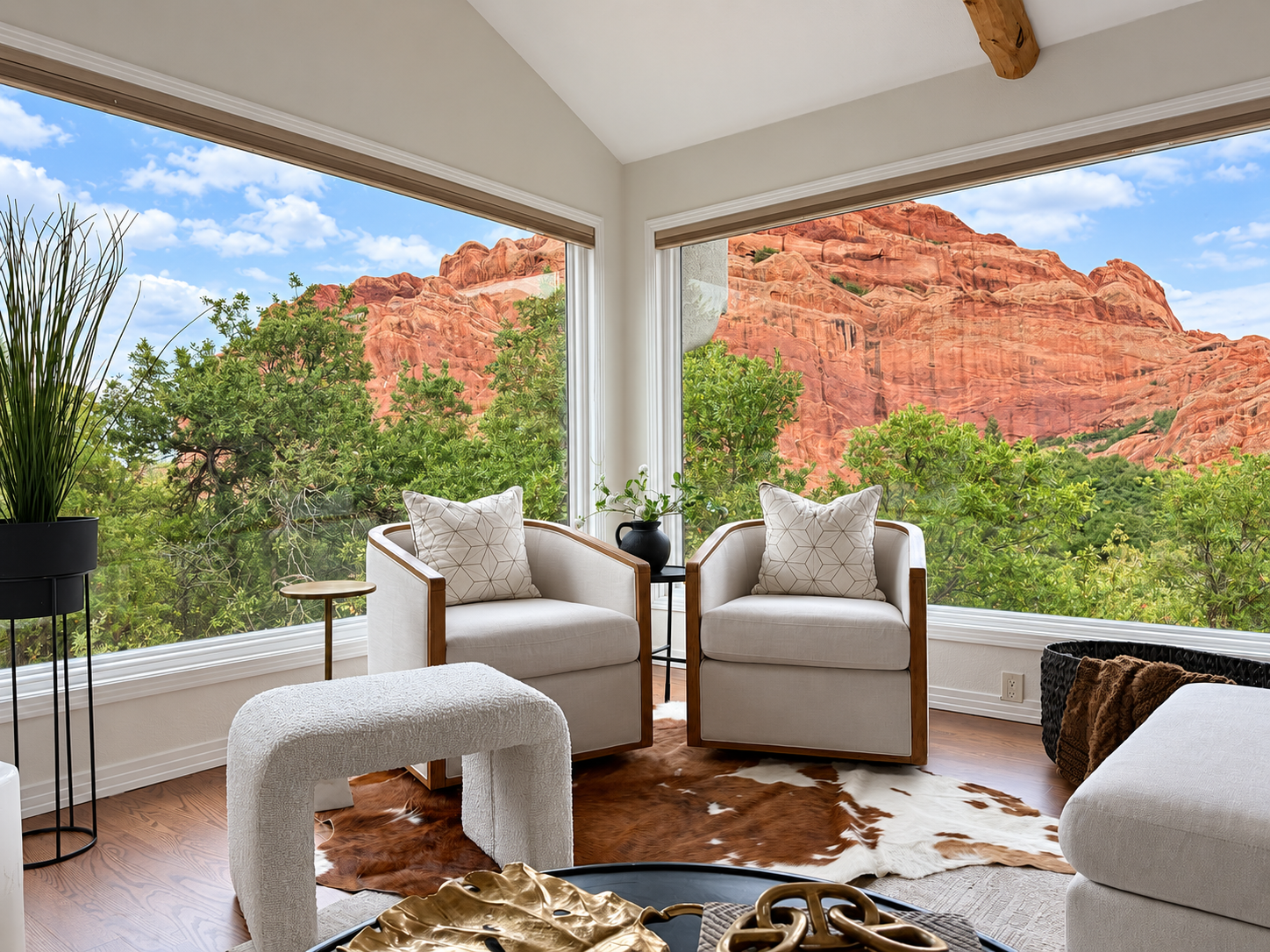 Swivel armchairs with floor-to-ceiling corner windows overlooking Roxborough red rocks at 10276 Totem Run