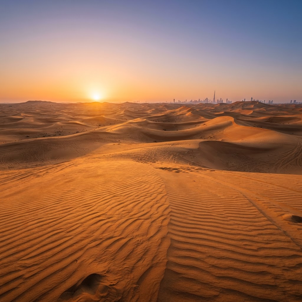 Golden desert dunes near Dubai at sunset with rippled sand patterns and warm orange and amber light