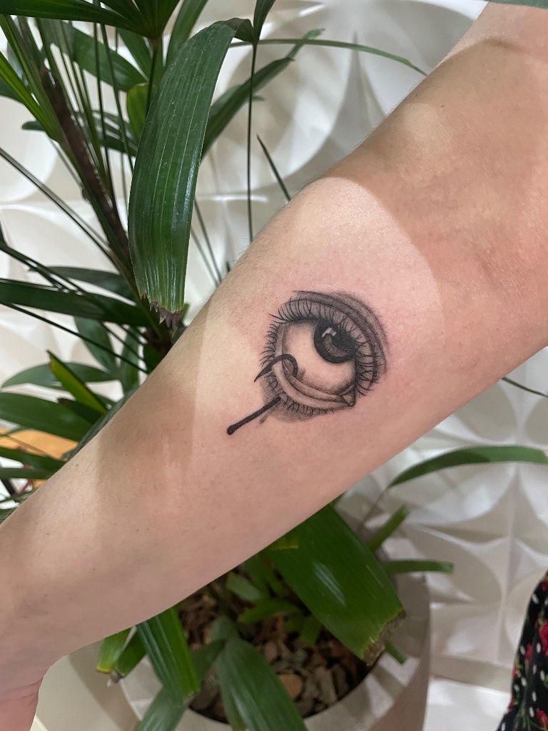 Realistic eye tattoo on forearm