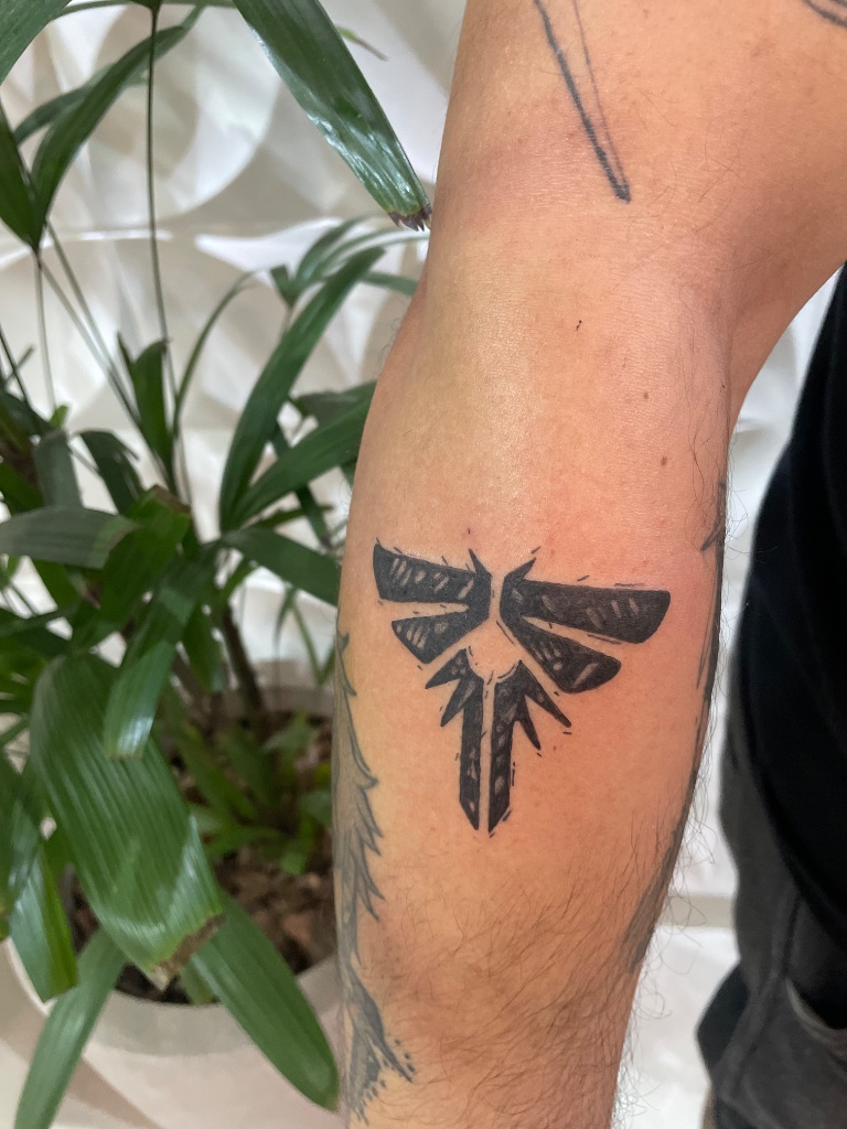 Blackwork firefly tattoo on arm