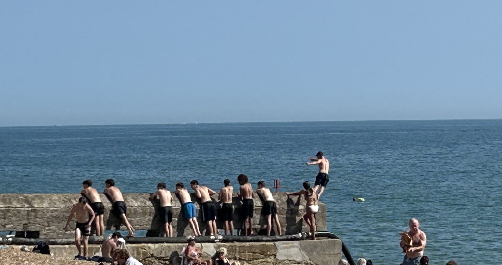Kids jumping into the sea, fully present in the moment