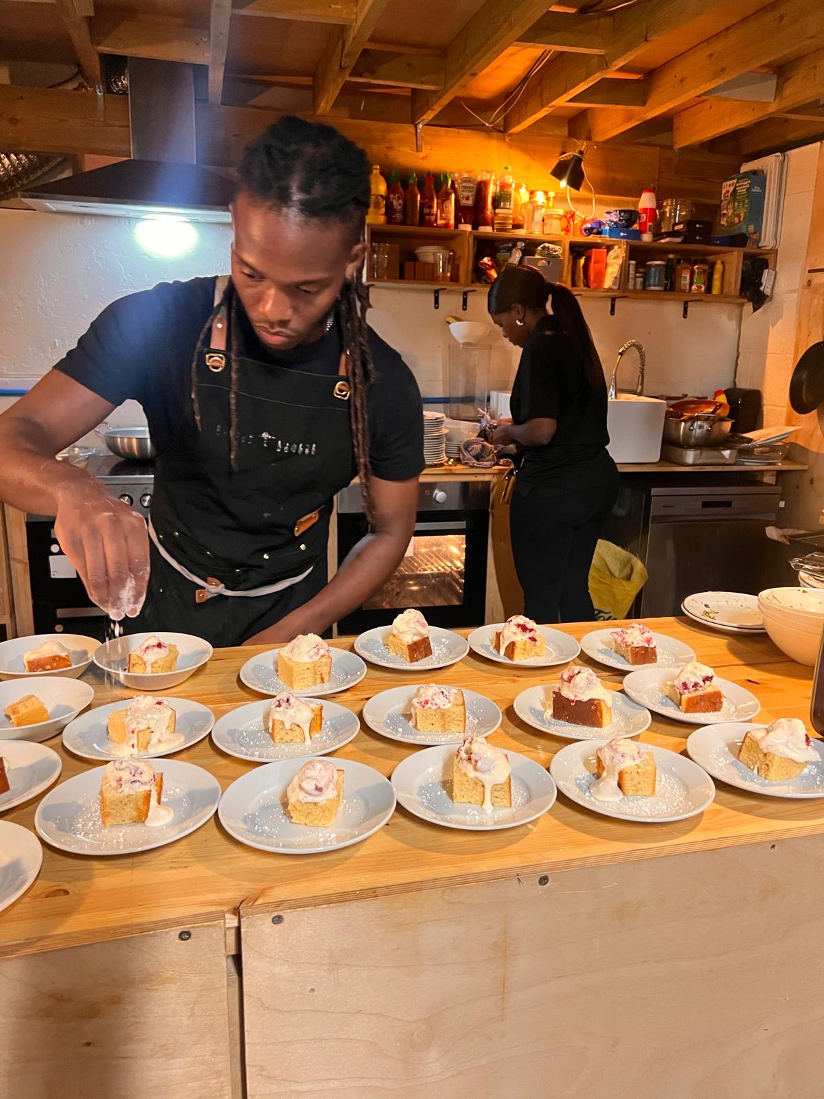 Chef finishing the salted caramel malva cakes with berry-ripple ice cream