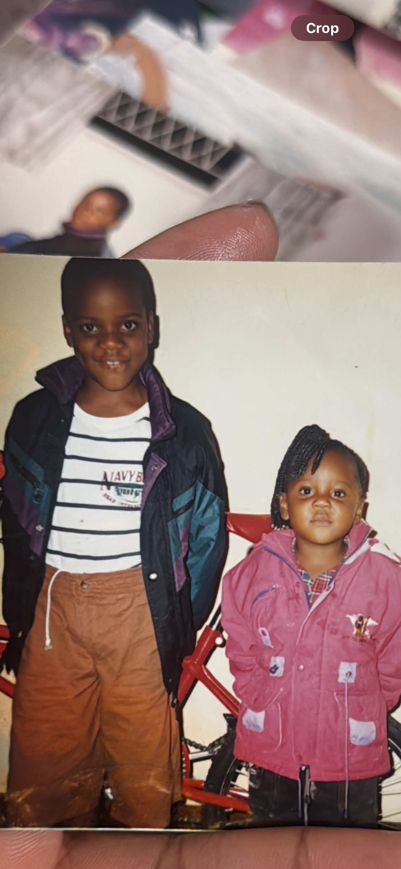 A vintage photograph of two children posing indoors at Gogo's house