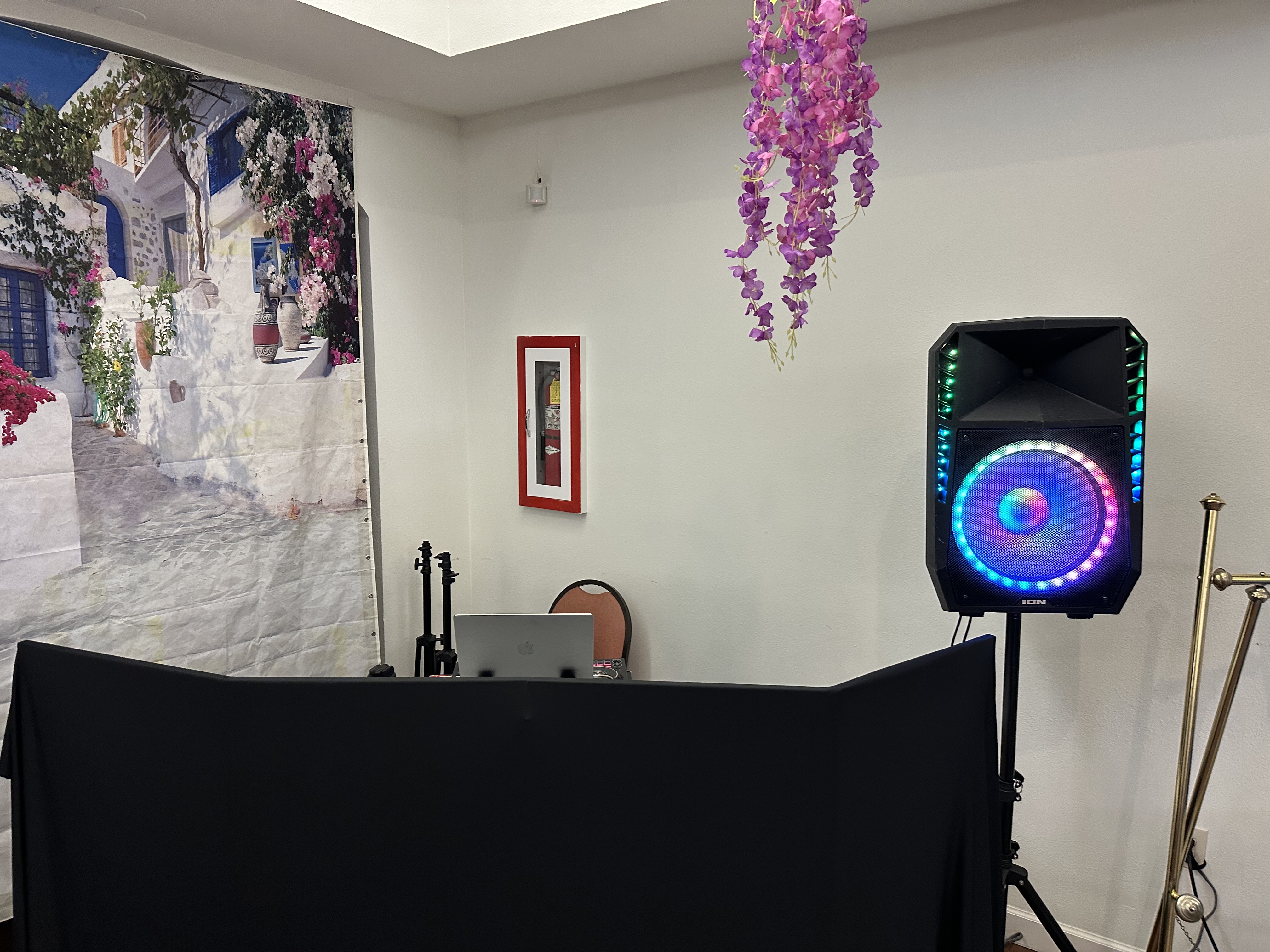 Professional DJ booth setup with purple event lighting