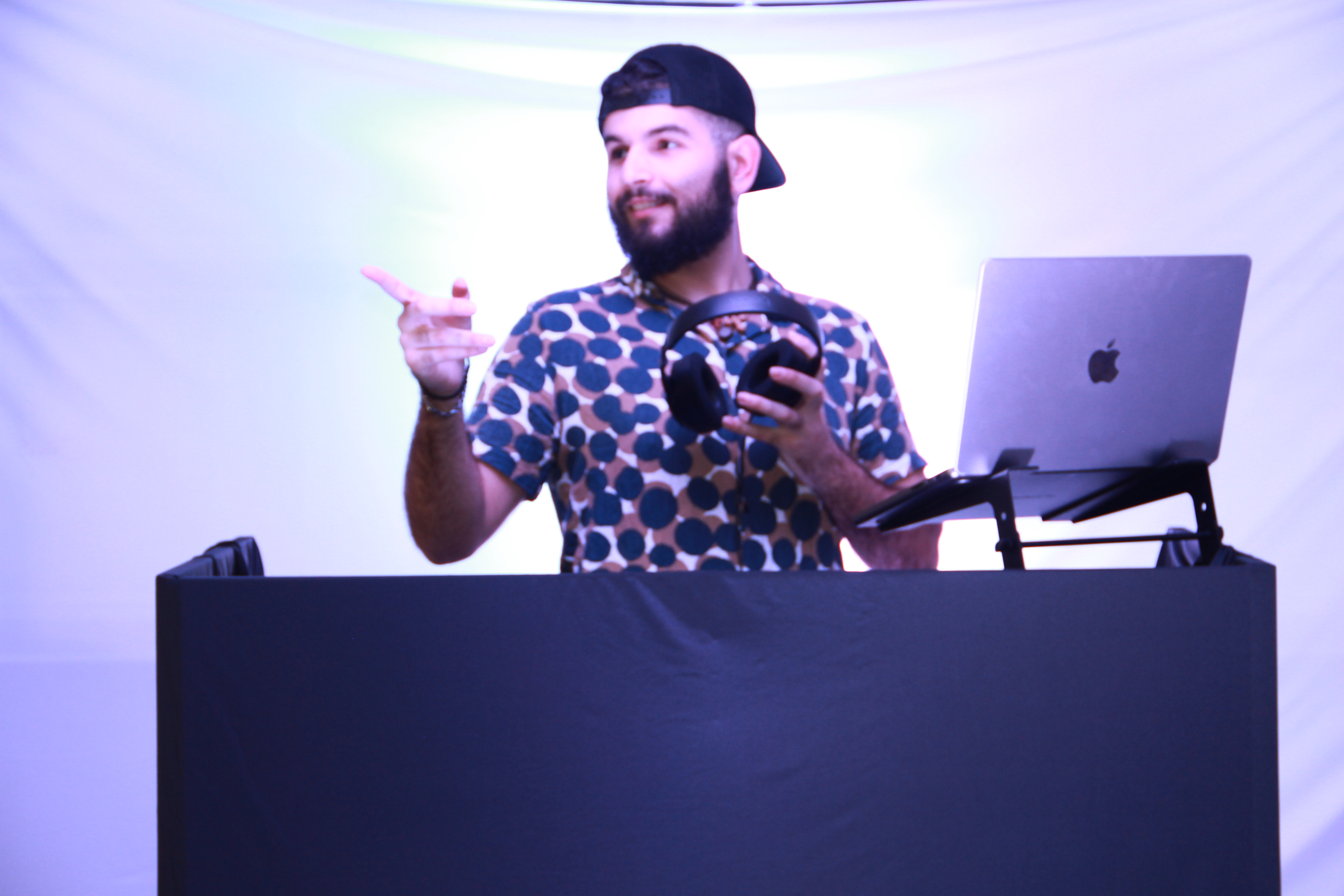 RogueMen DJ performing behind the booth at a live event