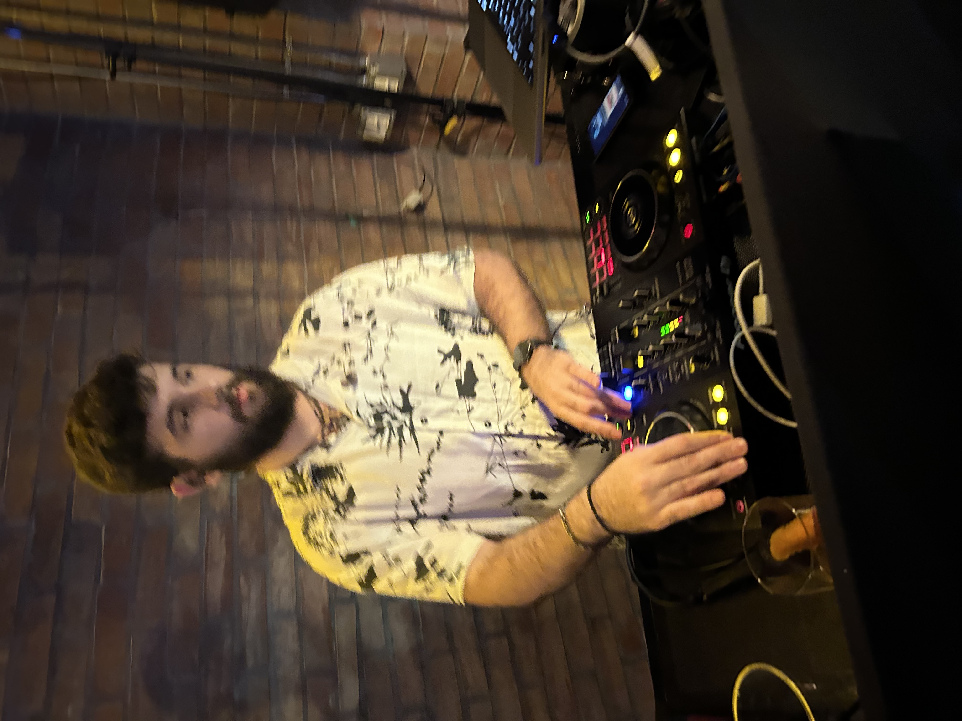 DJ performing behind a professional booth at a wedding