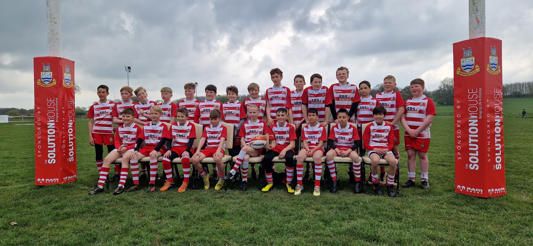 Junior rugby players in SPS Technical sponsored red and white shirts