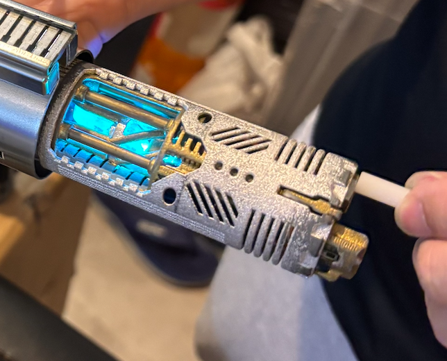 A circa 2015 nylon chassis installed and glowing — functional and secure inside the hilt.
