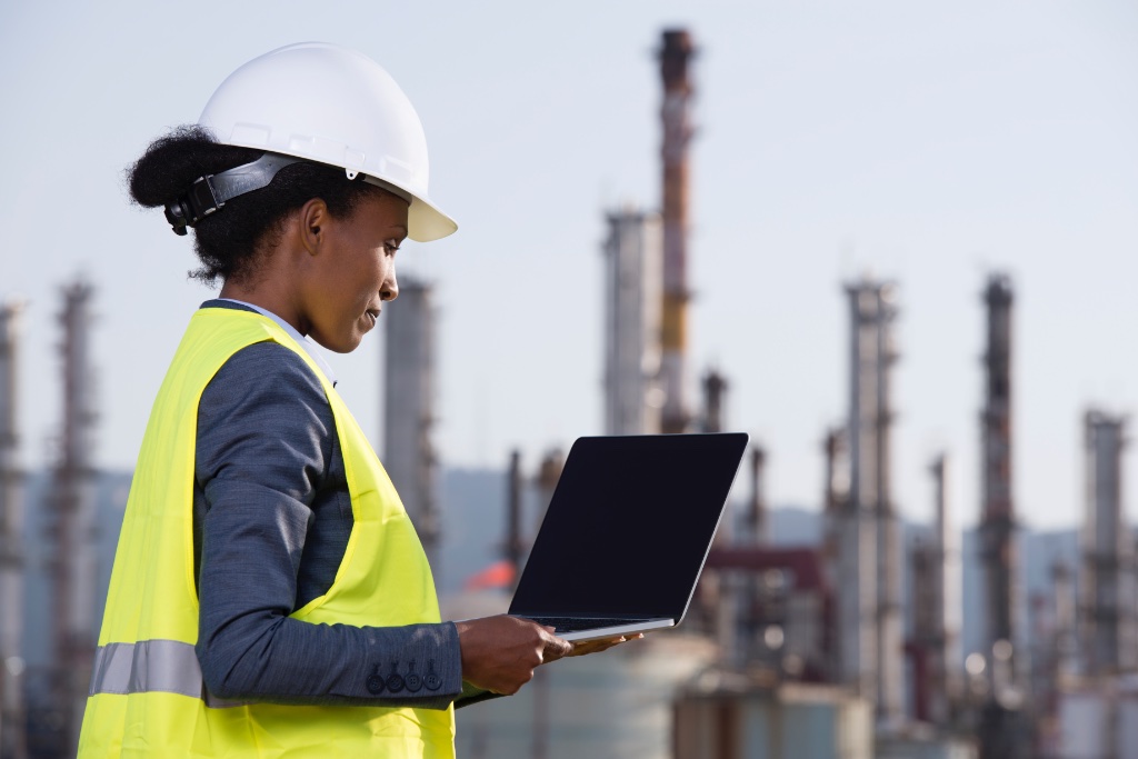 Industrial worker with laptop on site