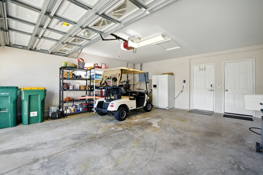 Large two-car garage with beach gear and elevator access at Pinnacle, Unit 2503 Naples FL luxury vacation rental