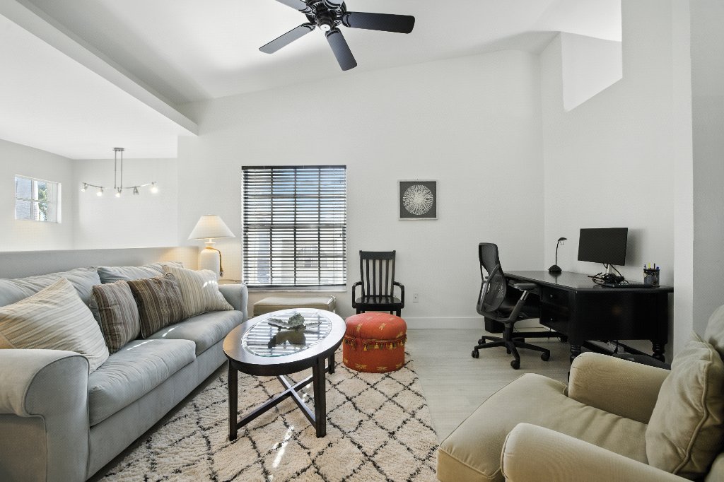 Bonus room third angle showing sofa, office desk and vaulted ceilings at Pinnacle, Unit 2503 Naples FL