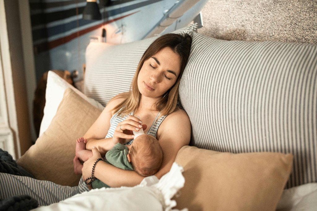 Mother resting with baby