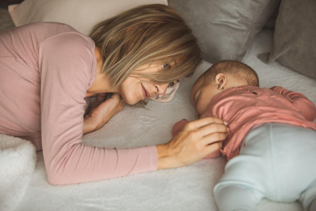 Mother lying with sleeping baby