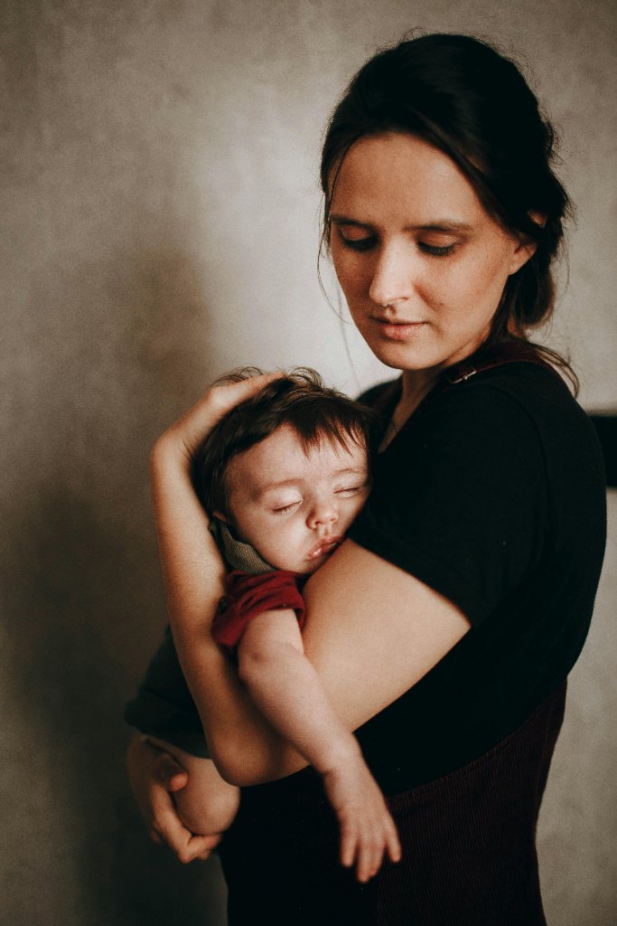 Mother holding sleeping baby