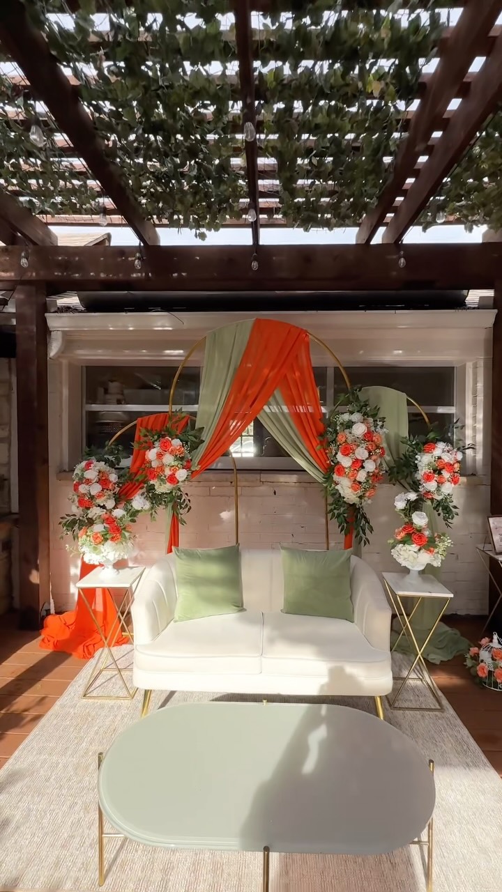 Sage and orange floral pergola lounge event decor Dallas TX