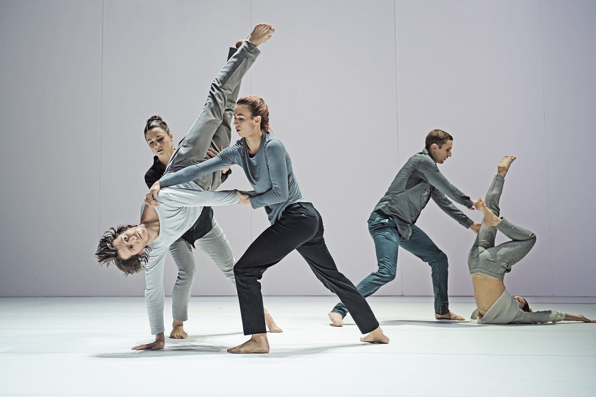 Fall Seven Times: a dancer held upside down mid-air by two partners
