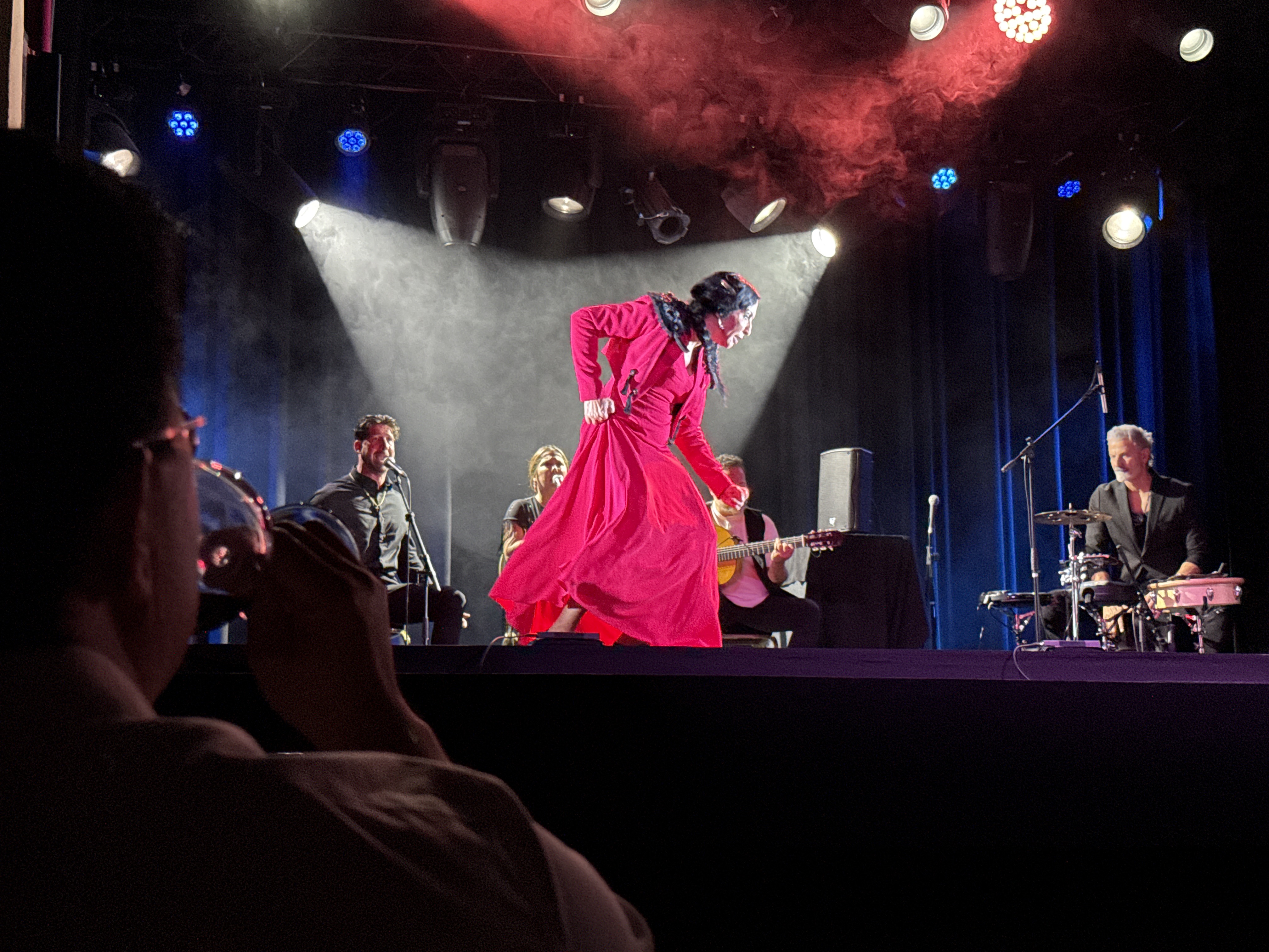 Francesca Grima 'La Chica' dancing in a red flamenco dress through stage haze