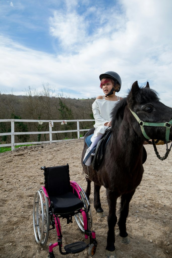 Young girl with disability riding a horse - a breakthrough moment of freedom and healing