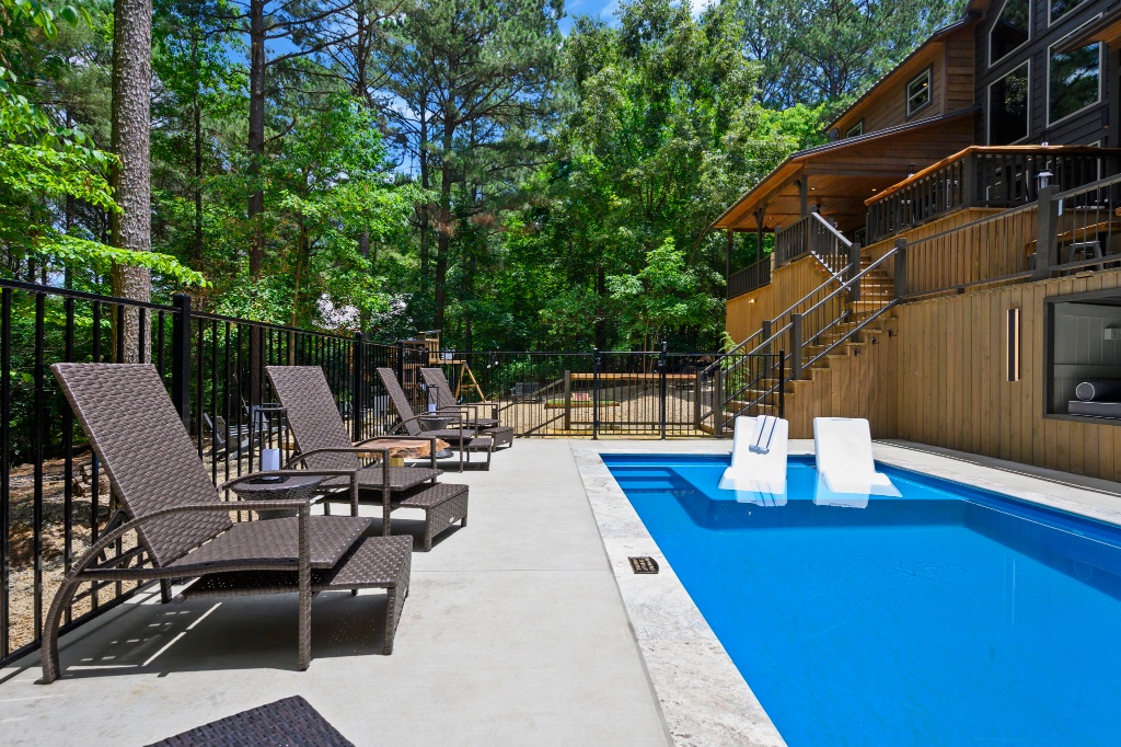Pool Area - Full View with Lodge & Red Umbrellas