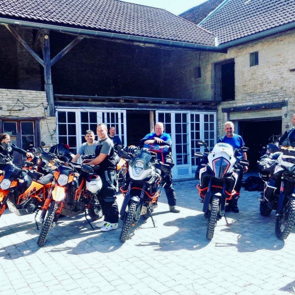 KTM adventure bikes outside a stone courtyard