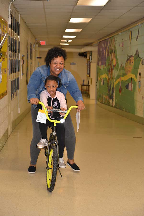 Student receiving bike from Bikes for Kids program