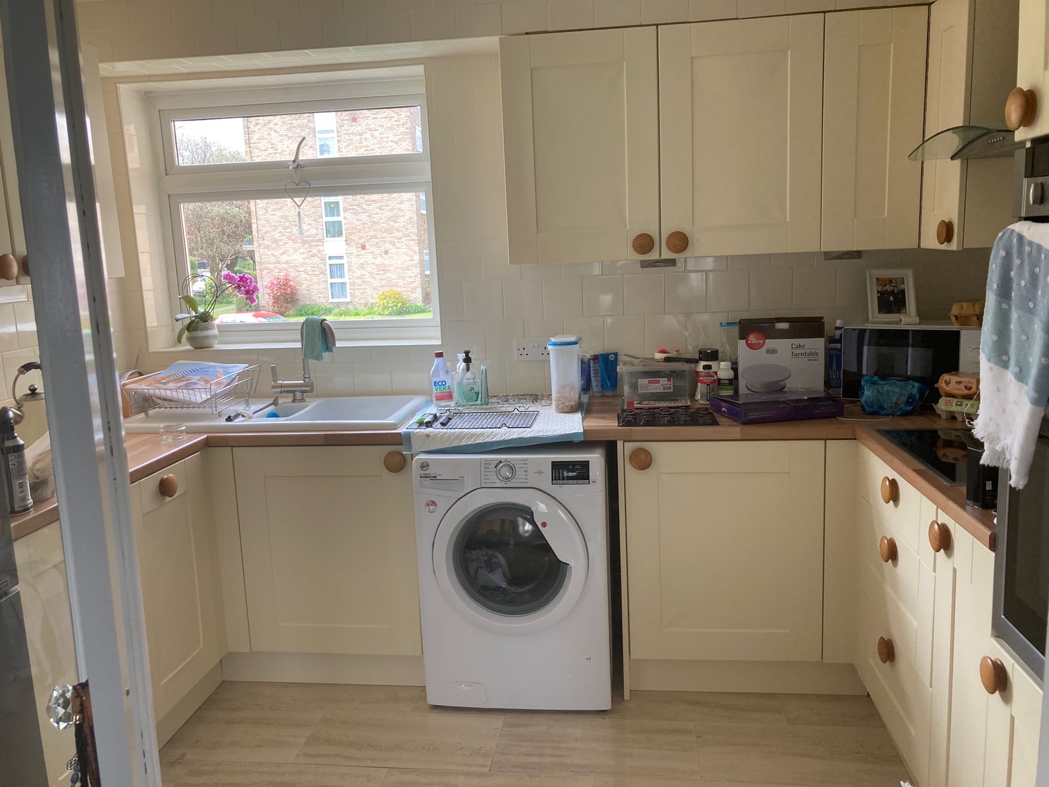 Kitchen before spraying, with cream cupboard doors