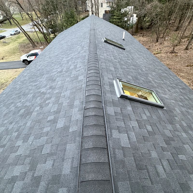 Completed architectural shingle roof with clean ridge vent