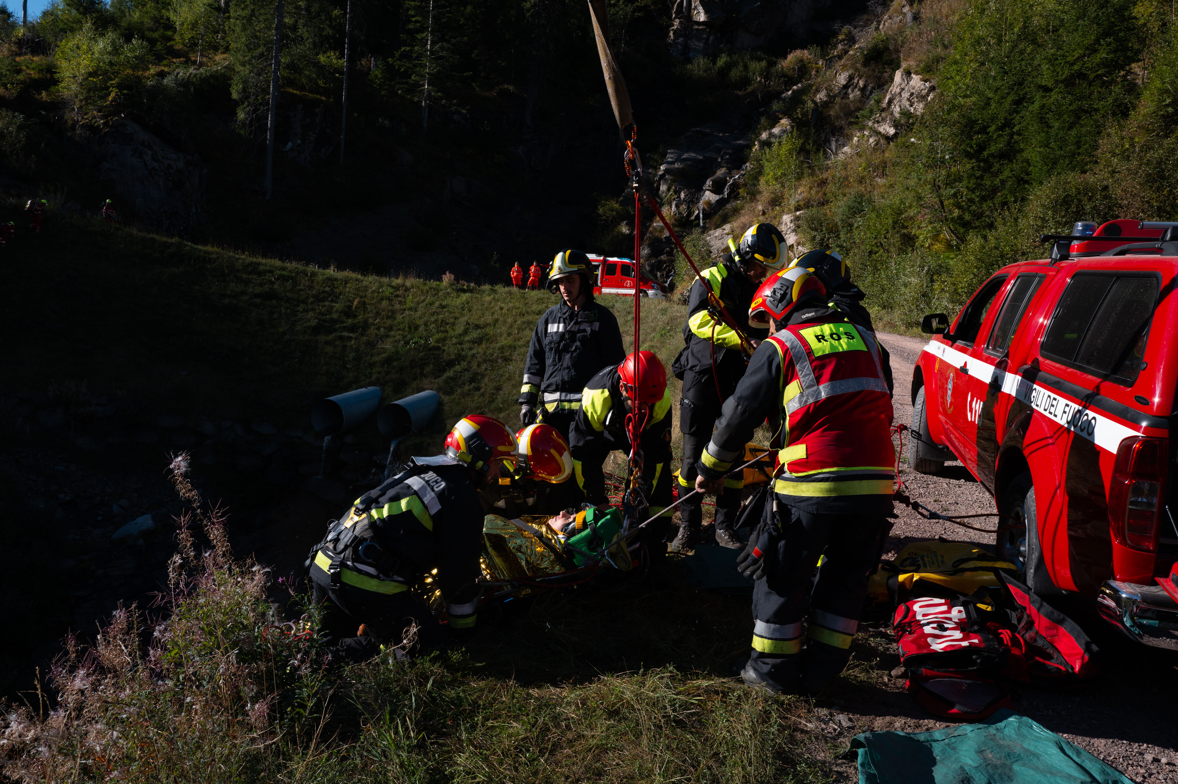 The crews recover an injured person with a stretcher and rope system along the cliff
