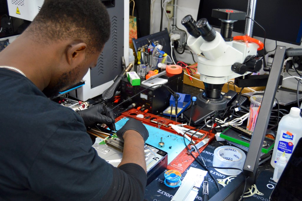 RepairRama technician performing micro-soldering water damage repair Bronx NY