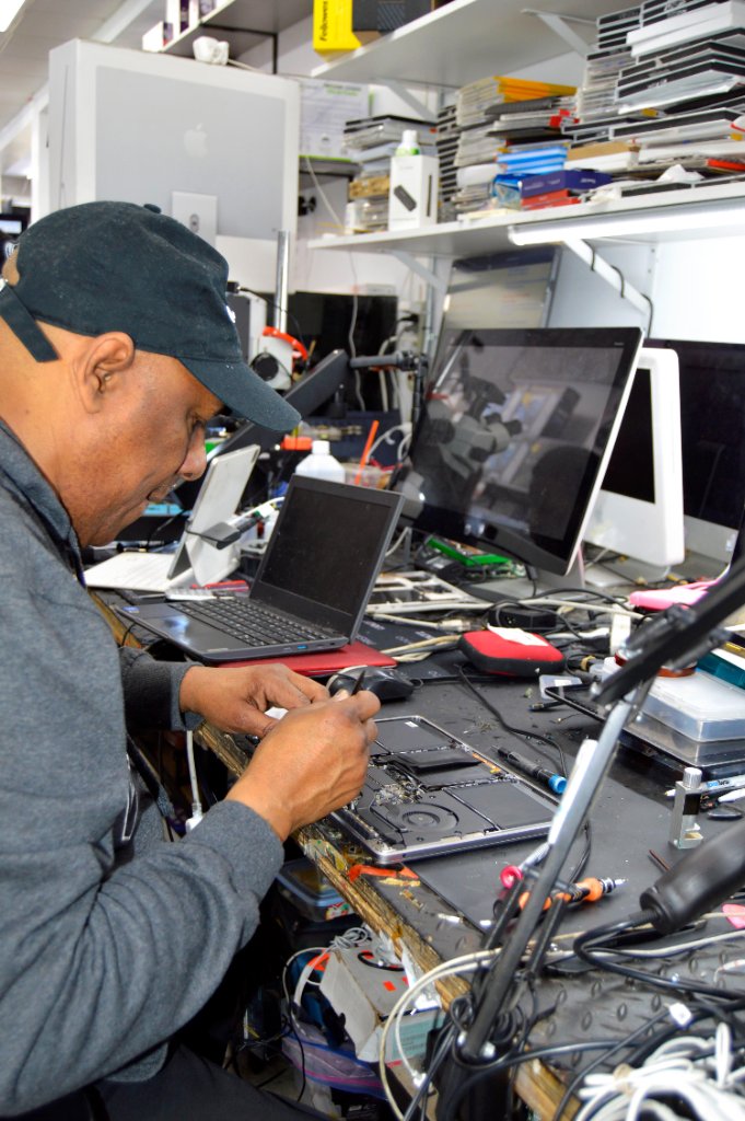 RepairRama technician repairing Xbox circuit board Bronx NY