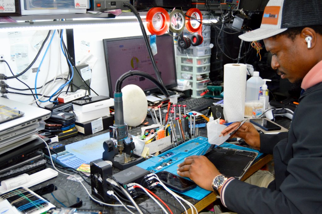 Technician repairing device at workbench