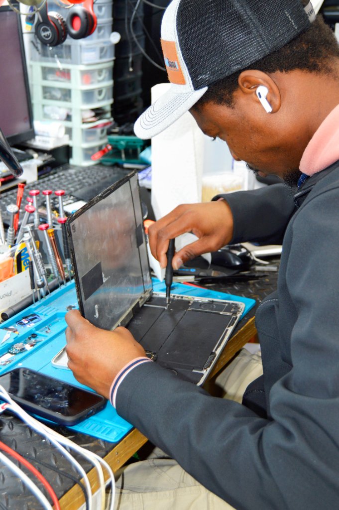 RepairRama technician repairing iPhone tablet Bronx NY