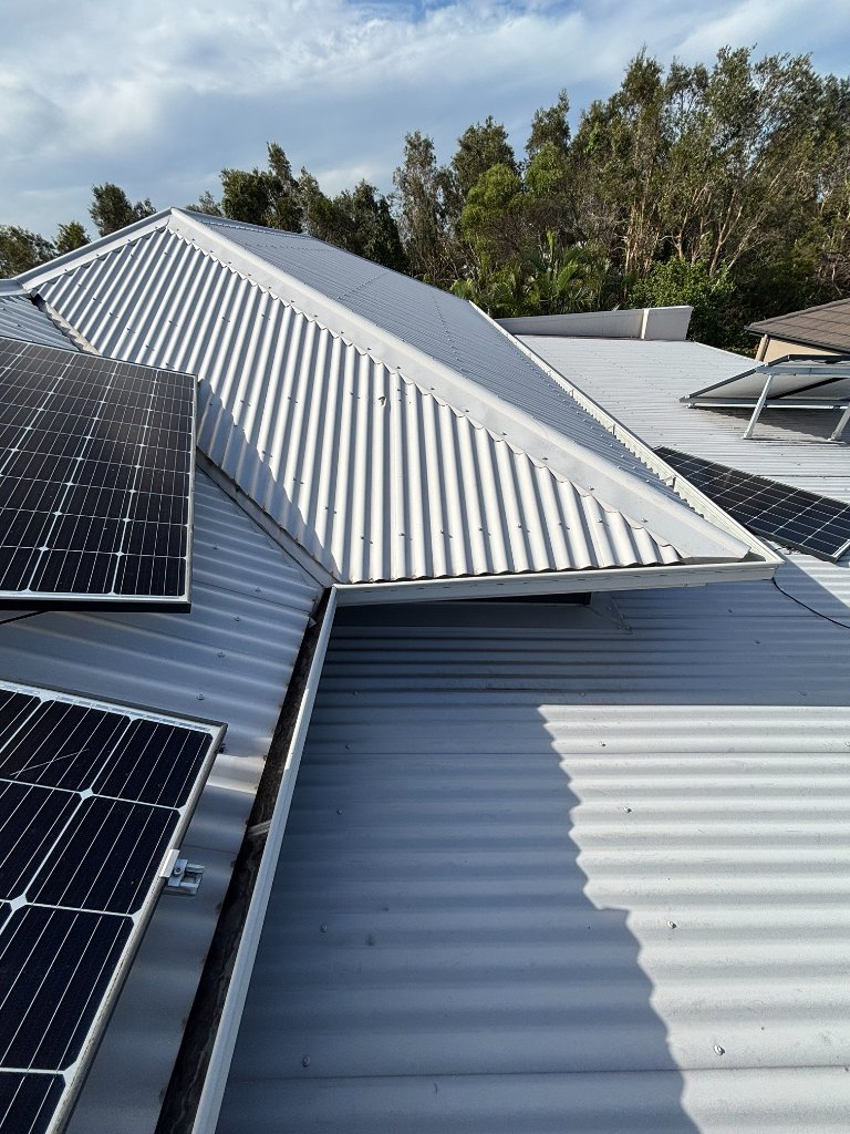 Before: Unsecured solar panels and damaged roof sheeting