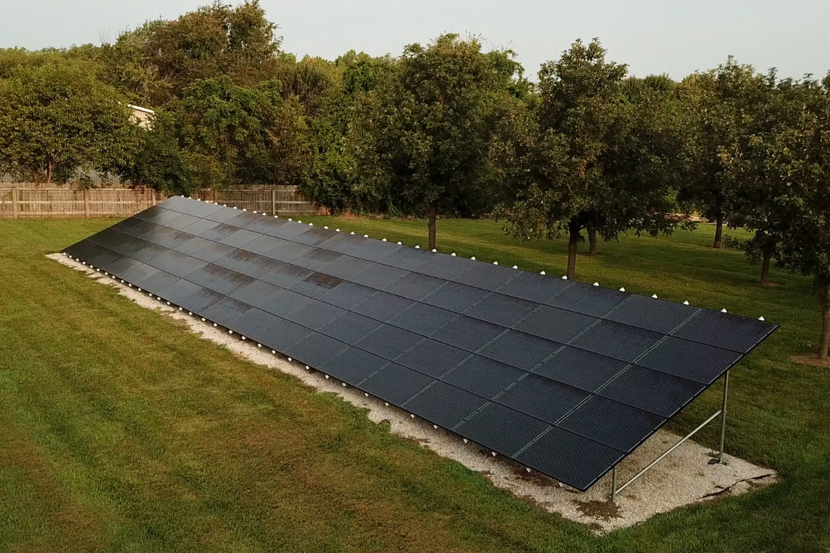 Aerial view of a ground-mounted solar panel array