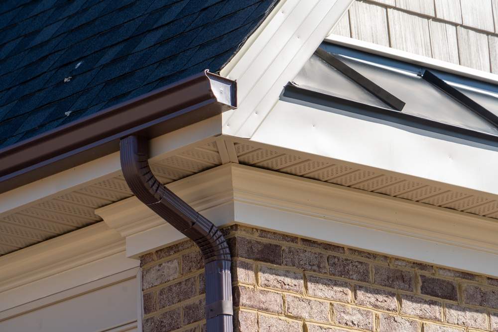 Seamless K-style gutter and downspout on a finished home exterior