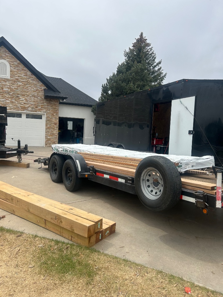 Car hauler trailer loaded with lumber Precision Rentals Wellington CO