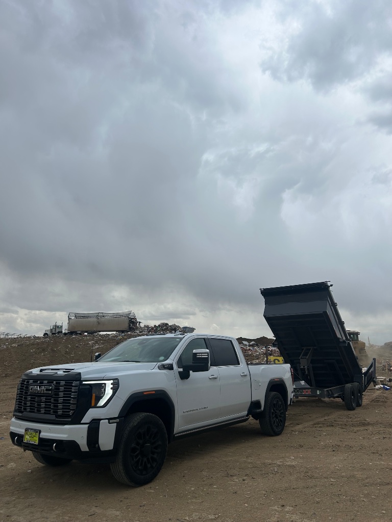 Dump trailer dumping load at landfill Precision Rentals Wellington CO