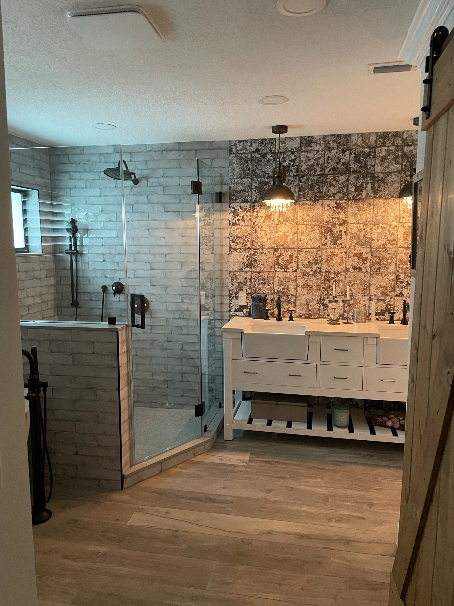 Finished bathroom remodel in Davie FL with a glass walk-in shower, double farmhouse vanity, and matte black fixtures