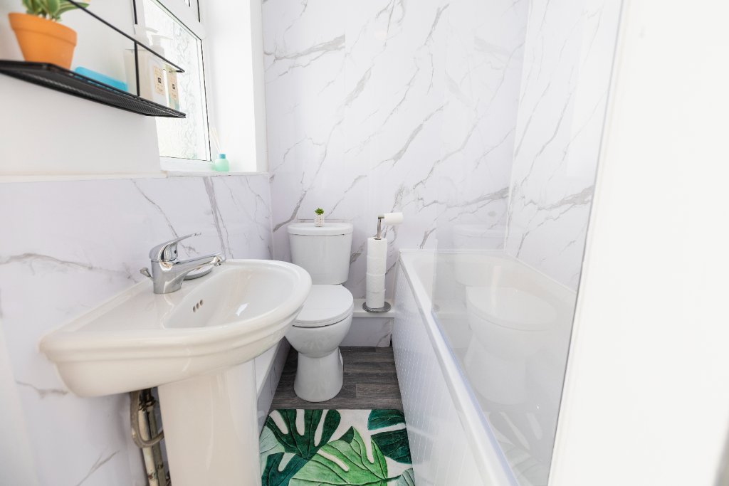 Bathroom with marble walls and bath